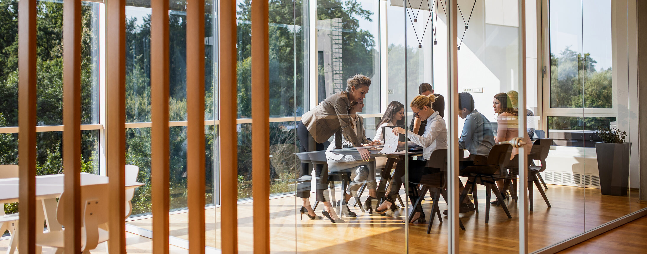 A group of colleagues are working together in a conference room.